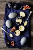 White chocolate ice cream with blueberries and figs in eggshells