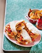 Prego rolls with chicken and cocktail tomatoes, served with potato wedges