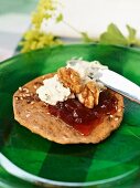 Cottage cheese with mint, nuts and strawberry jam on crispbread
