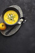 Creamy yellow tomato soup with saffron and green asparagus