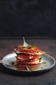 A polenta, tomato, pork escalope and ham tower