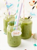 Green smoothies for Halloween decorated with straws and speech bubbles