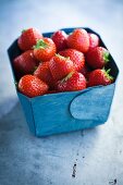 Strawberries in a blue cardboard box
