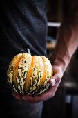 A man holding a pumpkin