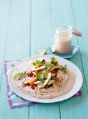 Chicken, vegetable and feta cheese wraps with a spicy yoghurt sauce
