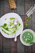 Spinach soup with crème fraîche, pink pepper and fresh spinach