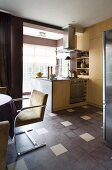 Island counter and dining area with retro armchairs in kitchen