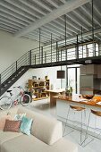 Living area in open-plan loft apartment with mezzanine