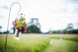 A bouquet hanging in a glass jar