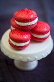 Red macarons for Valentine's Day on a porcelain cake stand