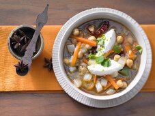 Oriental vegetable soup with chickpeas, coriander and cream cheese dumplings