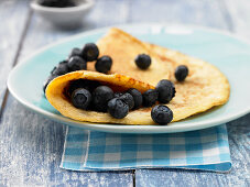 A coconut and rice omelette with blueberries