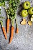 Fresh carrots, ginger and apples (seen from above)