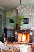 Open fire and flower arrangement in vintage interior