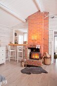 Wood-burning stove and brick chimney breast next to hatch leading to kitchen