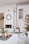 White, festive living room with Swedish tiled stove