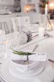 Table festively set with white crockery