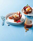 Biscuit dough bowls with vanilla ice cream, caramel sauce and strawberries