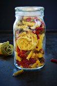 Tagliatelle and colourful fusilli in a preserving jar