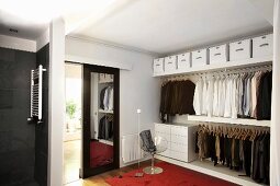 Mirrored sliding doors in elegant, masculine dressing room