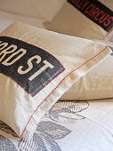 Vintage-style cushions cover with appliqué lettering