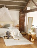 Rustic beams and brick pillar in gallery bedroom of loft apartment