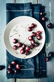 Fresh cherries on a plate and next to it