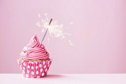 Pink cupcake decorated with a sparkler