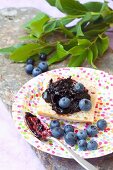 Bread with blueberry jam and fresh blueberries