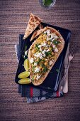 A naan bread with chickpeas and feta