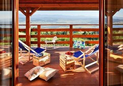 Loungers with wooden crates used as side tables on balcony