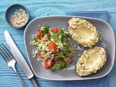 Avocado with an almond crust served with bulgar wheat and tomato salad