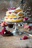 A two-tier choux pastry Paris Brest cake with cream and fresh berries