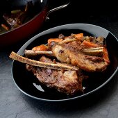 Braised beef ribs with carrots, celery and onions
