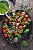 Chicken skewers with pesto, tomatoes and basil