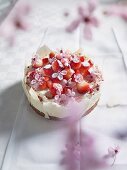 A small strawberry cake with white chocolate and pink flowers