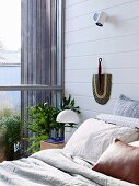 Bedroom with white painted wooden paneling and glazing