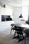 Various chairs around black dining room in kitchen