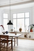 Bay window and rustic wooden floor in minimalist dining area