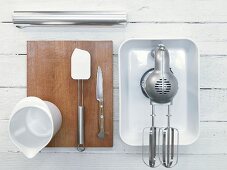 Various kitchen utensils: blenders, mixing cups and dough scrapers