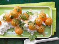 A melon salad with fresh cheese and a sweet and sour coriander dip