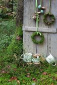 Shutter decorated with wreaths and wooden toadstools in woods