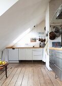 Kitchen with various fronts under sloping ceiling