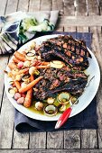 Barbecued shoulder of lamb with rosemary and garlic sauce and carrots