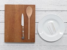 Plate, toothpicks, cooking spoon and knife