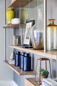 Various vases on wall-mounted shelves