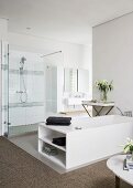 White bathtub and shower area in elegant modern bathroom