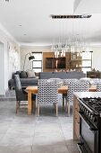 Upholstered chairs around dining table in open-plan interior