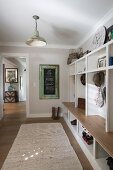 Open-fronted shelves with integrated bench in foyer