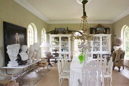 Long dining table and collection of busts in grand dining room